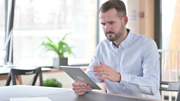 Failure Young Man with Loss on Tablet in Office