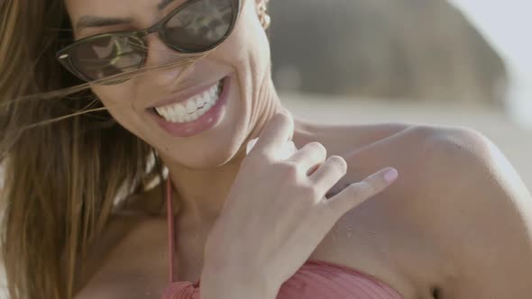 Closeup of Girls Hand Putting Piece of Ice on Friends Neck