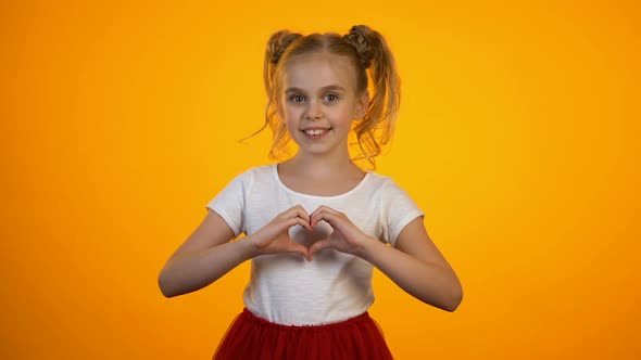 Adorable Teen Girl Making Heart With Hands, Love and Care, Cardiology and Health