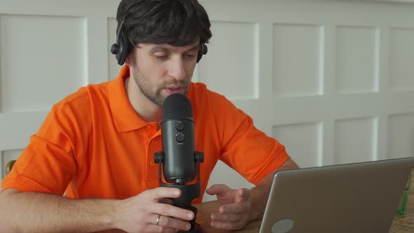 Man Is Speaking in Microphone in Studio Recording Podcast Gesturing Expressing Opinions for Online