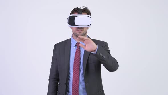 Young Hispanic Businessman Using Virtual Reality Headset