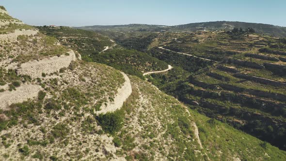 Aerial View of Green Rocky Desert Wild Mountain Area with Winding Road in Cyprus