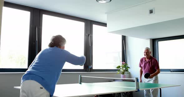 Senior couple playing table tennis