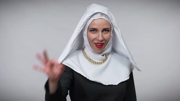 Beautiful Happy Woman in Nun Costume Showing Ok Hand Gesture Smiling Looking at Camera