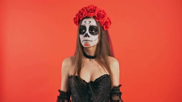 Day of Dead Confused Woman with Skull Makeup Crossed Fingers and Looking Up Like Waiting for Luck