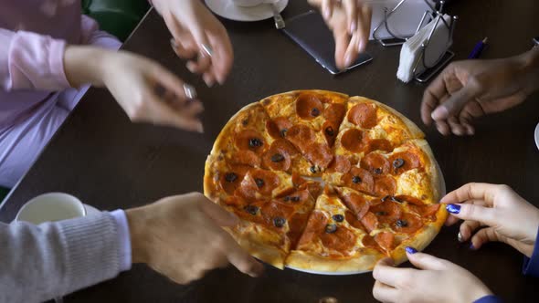 Friends Sharing a Pizza in a Restaurant