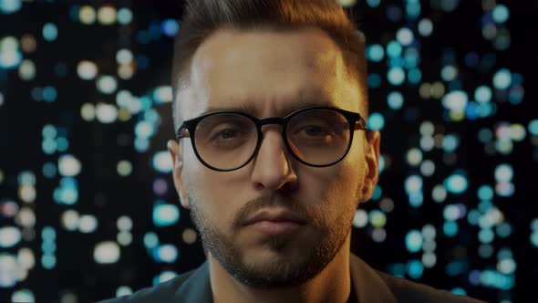 Close-up portrait of a young man working at the computer.