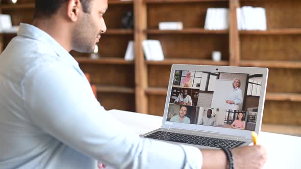 Indian Man Takes a Part in Online Conference with Multiracial Colleagues