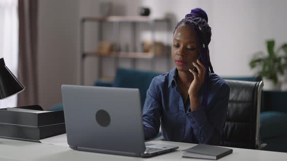 Female Sales Manager is Working in Home Office Black Woman is Calling By Mobile Phone Sitting at