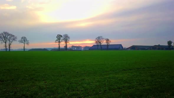 Aerial Cinematic Clip Drone Flying Over a Farm Field During Sunset