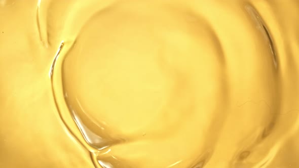 Super Slow Motion Shot of Swirling Golden Oil Liquid at 1000Fps.