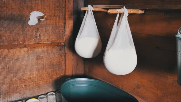 An Old Cheese Dairy. Fresh Cheese in Gauze Is Hung in a Traditional Wooden House