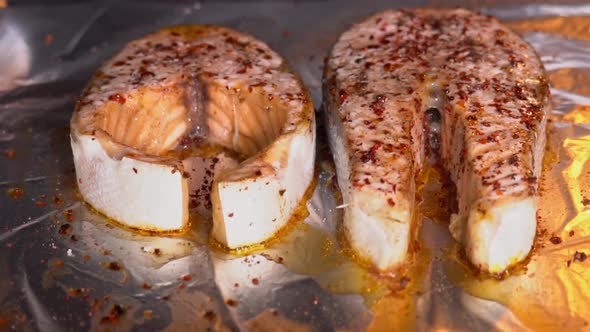 Salmon is baked in the oven close-up. Baking salmon steak. Salmon steak with spices roasting