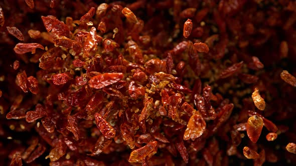 Super Slow Motion Shot of Dried Red Chili Peppers Explosion on Black Background at 1000Fps