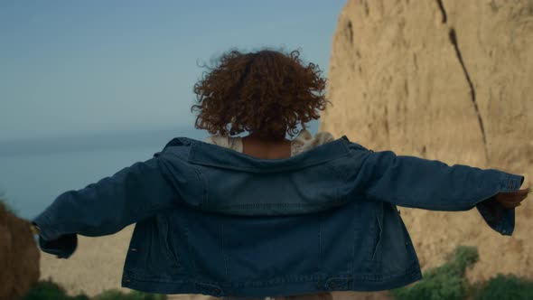 Young Woman Going Down Sea Shore to Beach Back View