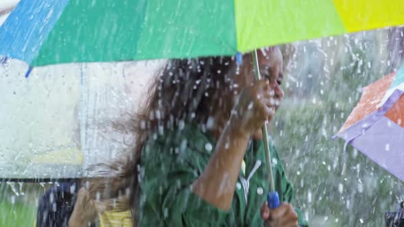 Laughing Children Jumping in Rain