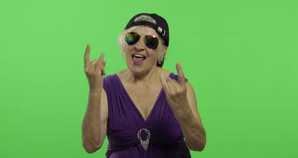 Elderly Woman in Sunglasses Shouts with a Smile and Showing Tongue. Chroma Key