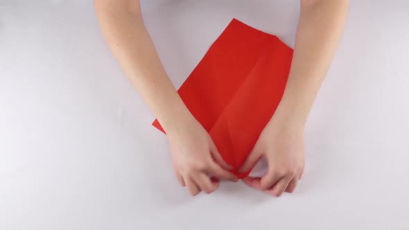 Girl Making Origami. Red Envelope. Time Lapse