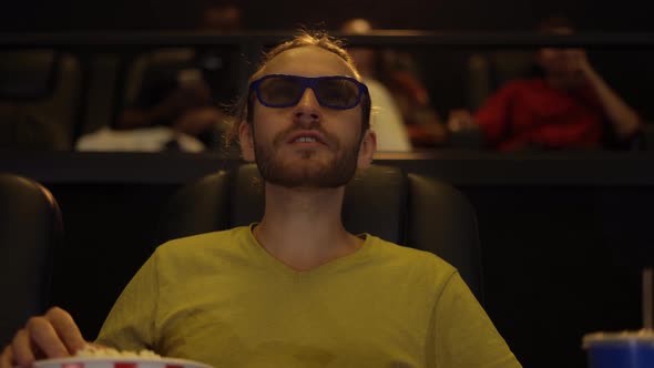 A Man in 3d Glasses Watching Movie at the Cinema and Eating Popcorn