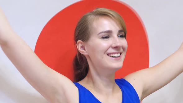 Japanese Young Woman Celebrates Holding the Flag of Japan in Slow Motion