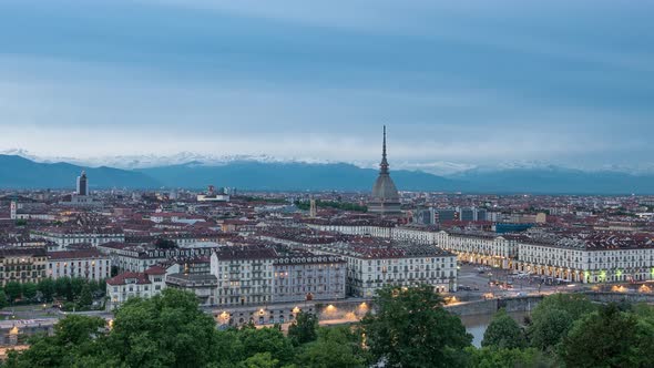 Timelapse day to night over Turin Italy, town wake up, colorful dramatic sky