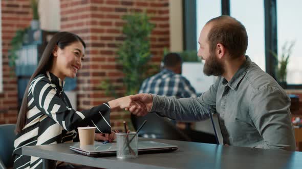 Asian Recruiter Greeting Candidate at Job Interview Meeting