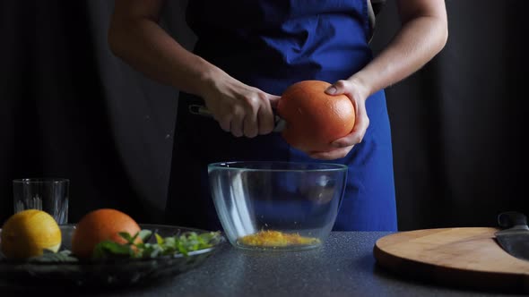 Woman removes grapefruit peel