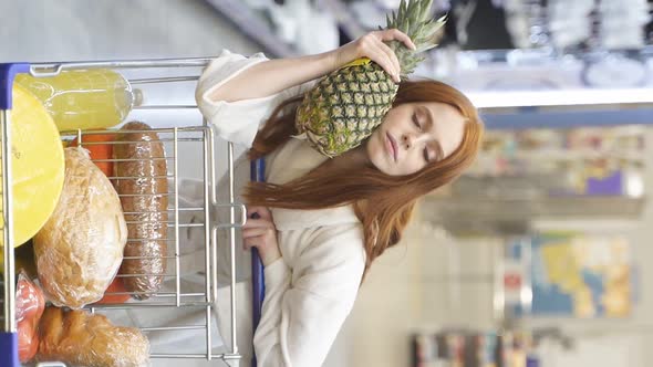 Adorable Woman Is Buying Pineapple in Store
