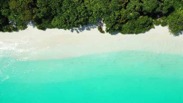 Luxury flying abstract view of a white paradise beach and blue sea background in 4K