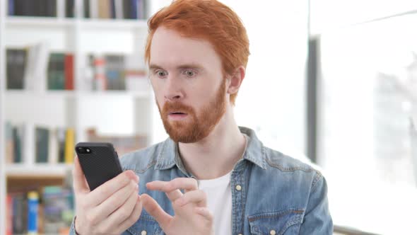 Casual Redhead Man Shocked By Results on Phone