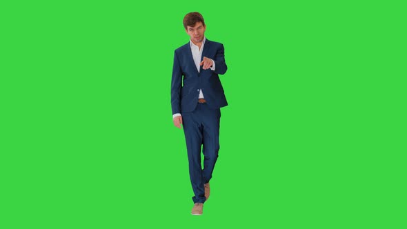 Businessman Walking and Explaining Something To Camera on a Green Screen, Chroma Key