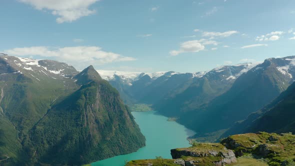 Scenic Mountain Views Near Olden With Calm Blue Waters Of Lake In Norway. - aerial