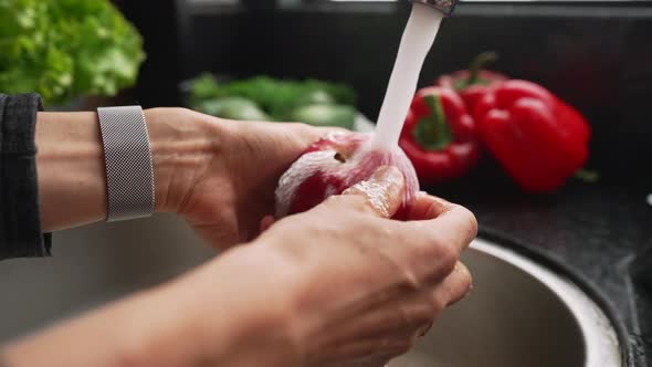 Female Hands Washing Apple Under Water in Sink