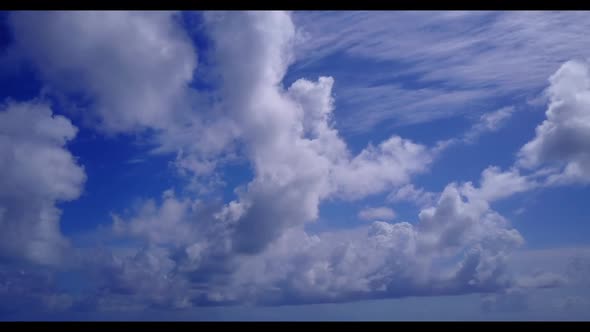 Aerial drone shot nature of tranquil seashore beach trip by blue green ocean with white sandy backgr