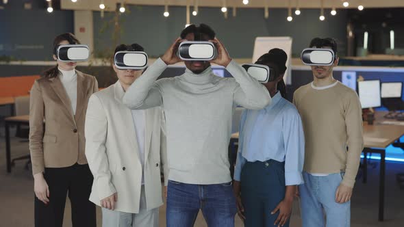 Multiracial Team Posing in VR Headset in Modern Office