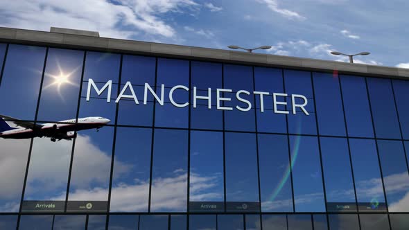 Airplane landing at Manchester England airport mirrored in terminal