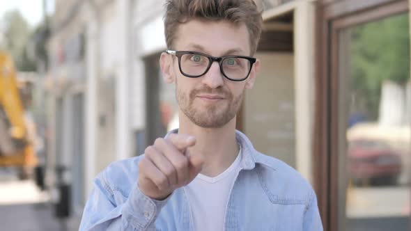 Casual Young Man Inviting New People While Standing Outdoor