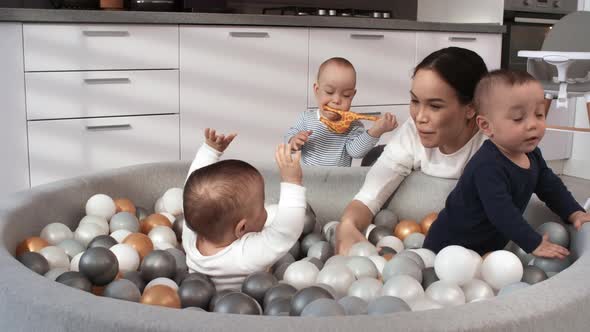 Asian Triplets Having Fun in Ball Pit