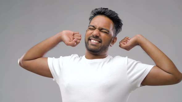 Indian Man Stretching Over Grey Background 6