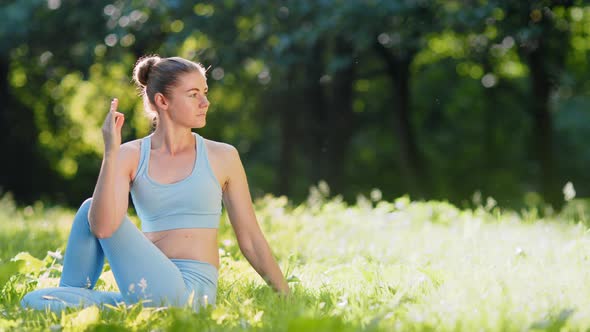 Young woman yoga practitioner in blue tracksuit changes relaxation poses