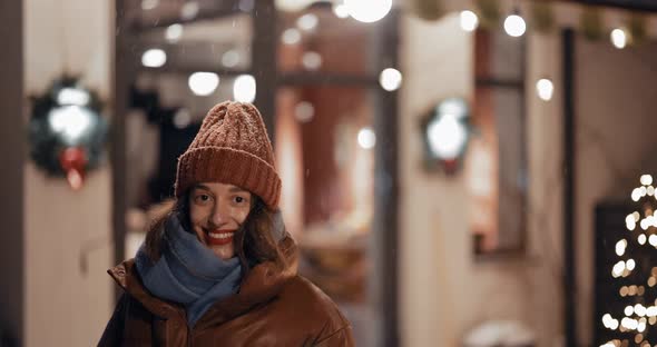 Portrait of Young Woman on the Backyard of Her House on Winter Holidays