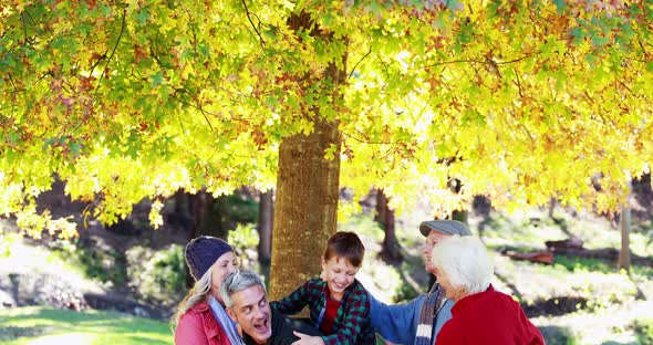 Multi-generation family standing in the park