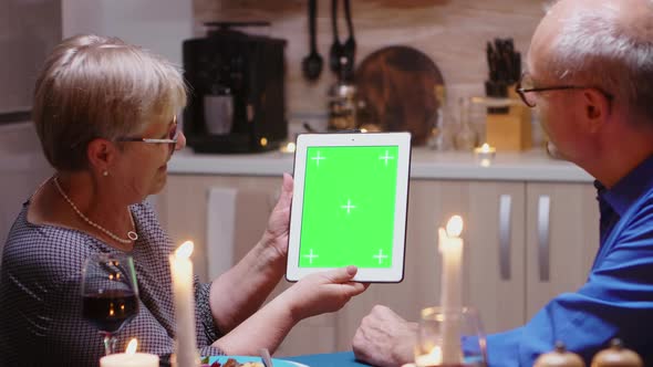 Old Couple with Green Screen Tablet