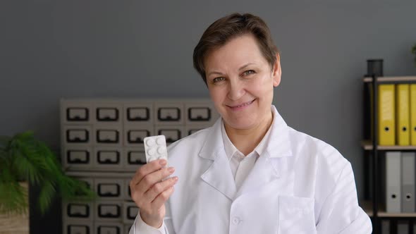 Portrait of a Senior Female Doctor 50s with Pills