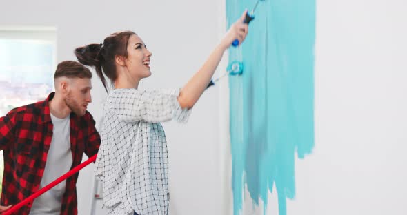 Close Up Portrait of Cheerful Young Couple Woman and Man in New Apartment Renovating Room