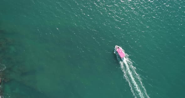 Aerial view of a sailboat sailing near Old city of Acre, Israel.