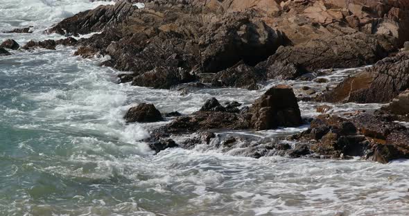 Sea water wave with stone cliff