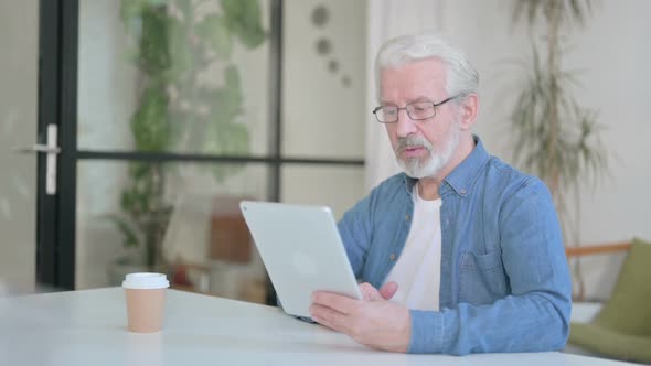 Senior Old Man Making Video Call on Tablet in Office