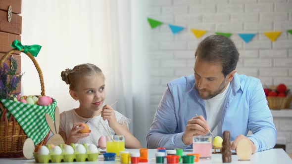 Cute Father and Daughter Preparation for Easter Celebration Painting Eggs