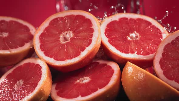 Slow Motion Shot of Grapefruit Water Splashing Through Grapefruit Slices